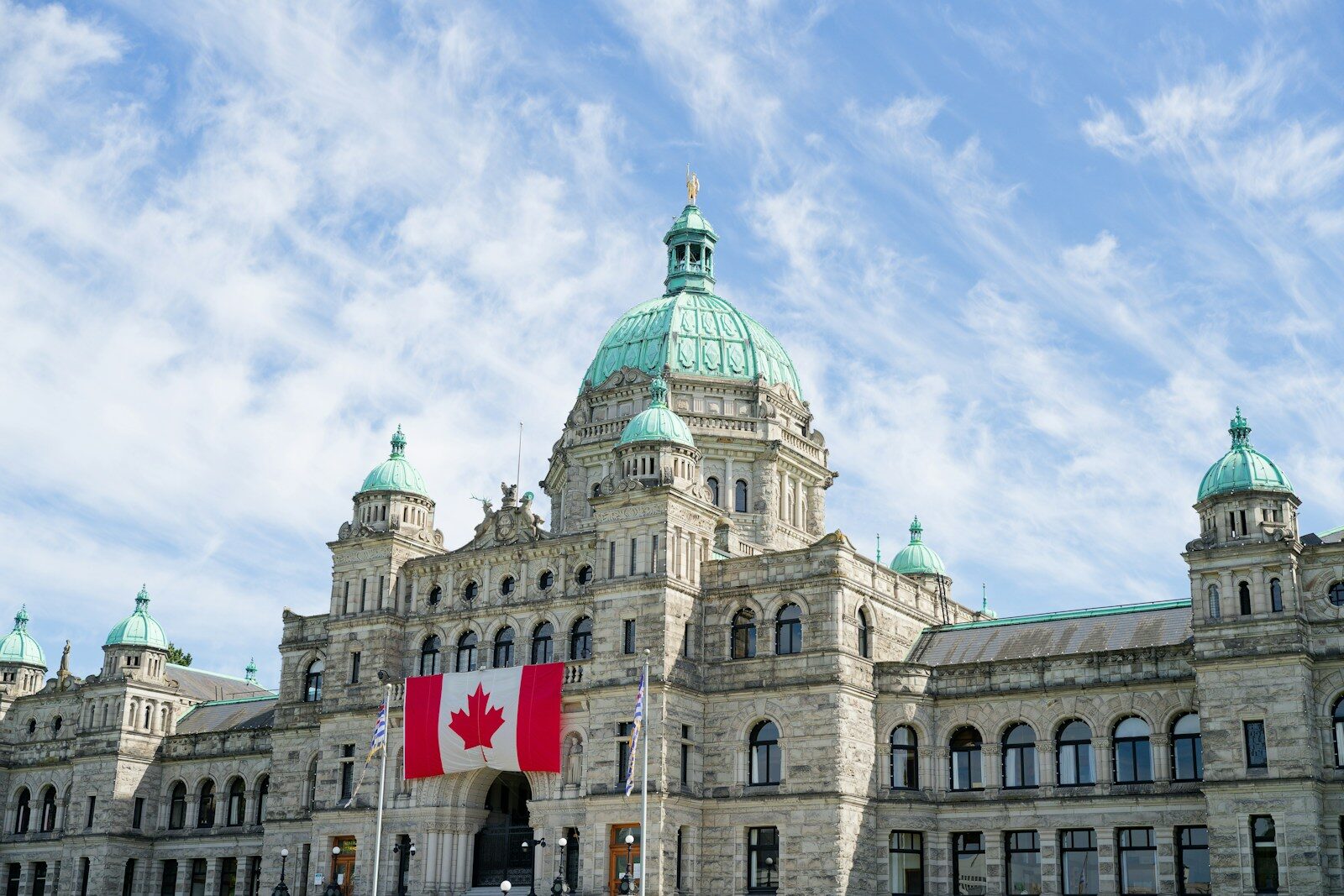 British Columbia Parliament Buildings with the Canadian flag in Victoria