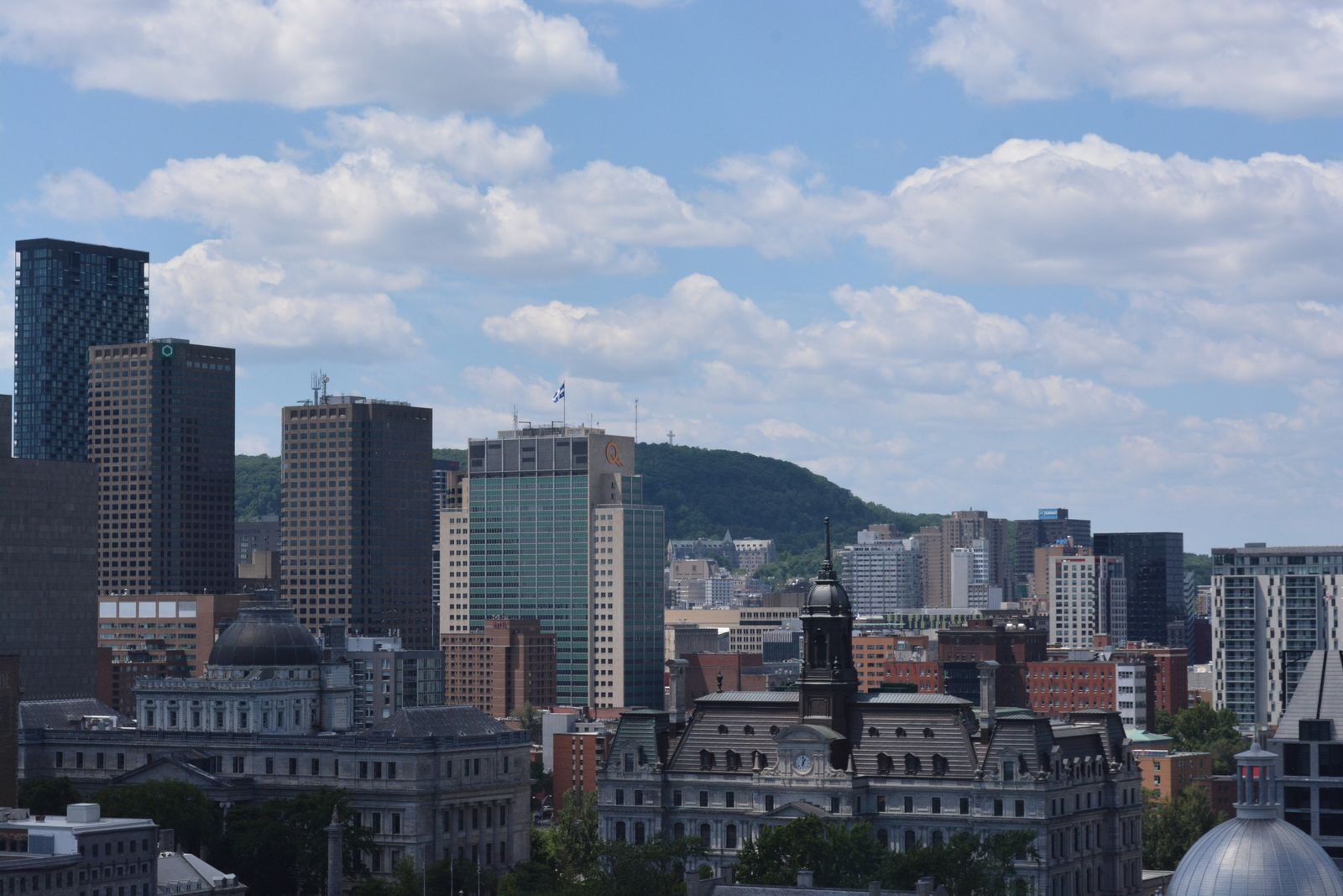 Montreal skyline with Mount Royal in the background under a blue sky