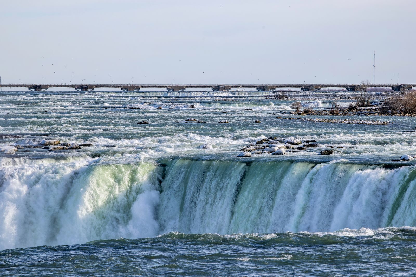 Niagara Falls seen from the Canadian side with the Rainbow Bridge in the distance