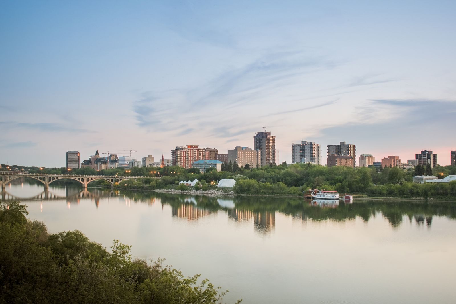 Saskatoon skyline reflected in the South Saskatchewan River at dusk
