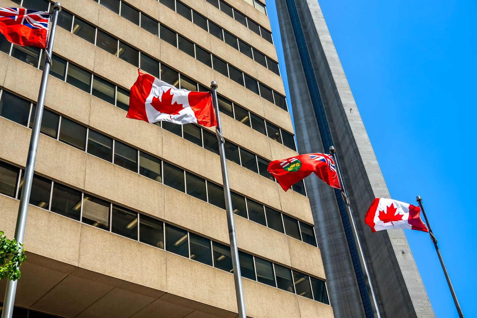 Canadian and Ontario flags near the CN Tower in Toronto